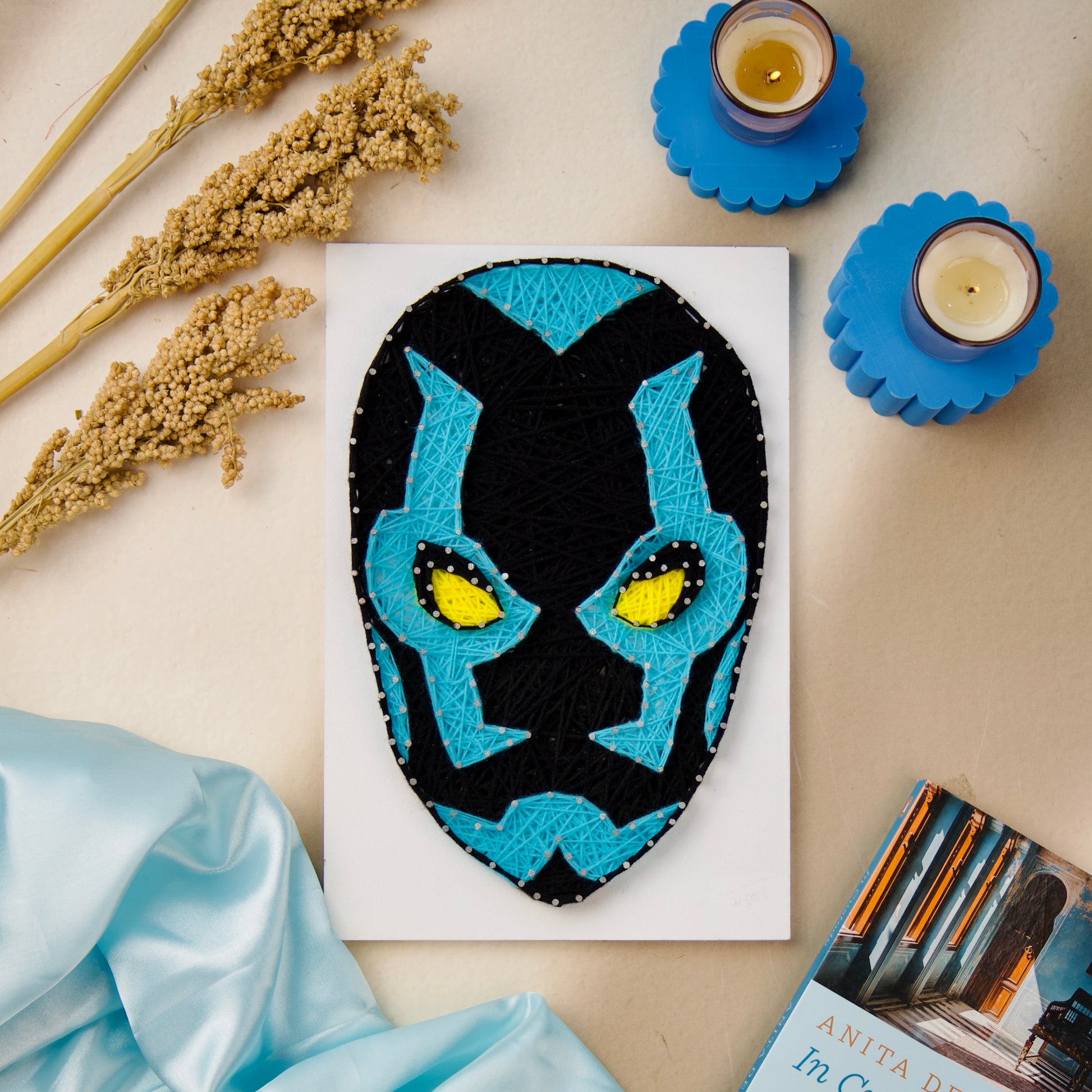 Handcrafted Blue Beetle face string art, perfect for DC fans and personalized wall decor collections.