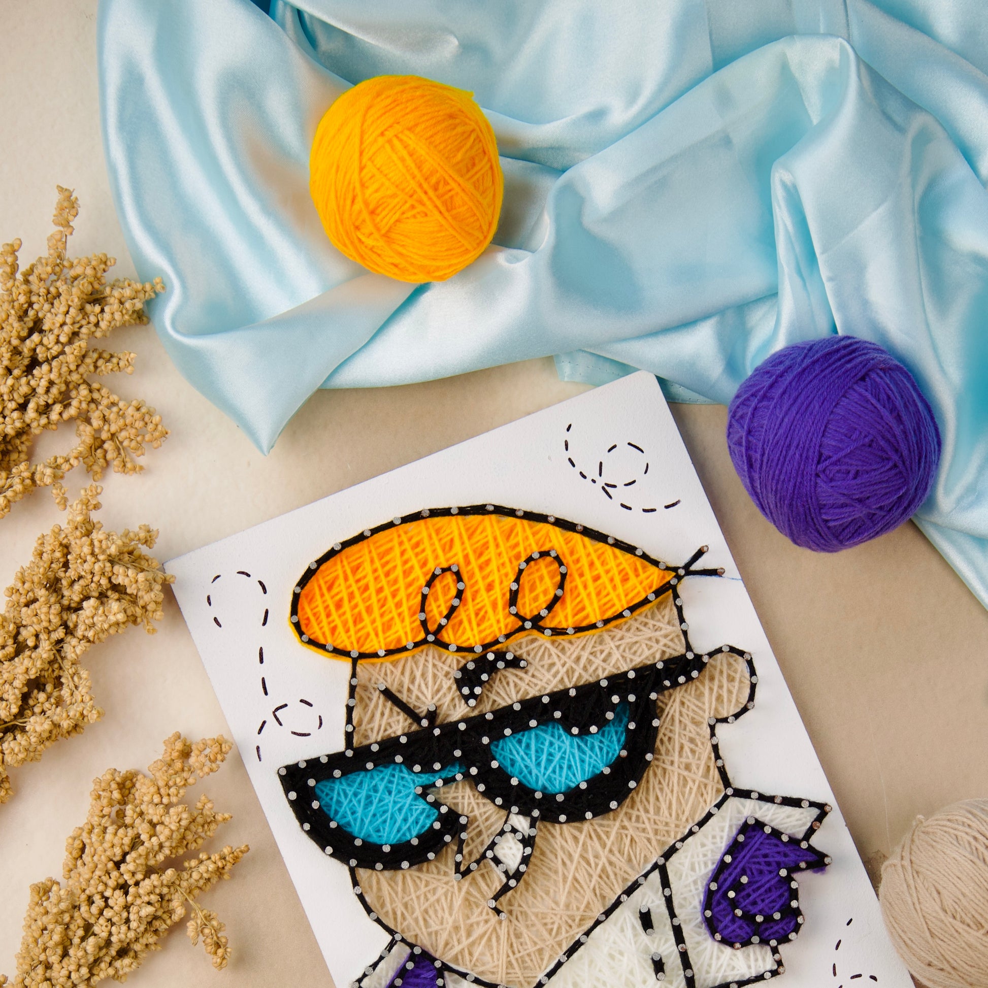 Handcrafted string art of Dexter from the iconic cartoon, made with colorful wool – creative geek decor for any space.