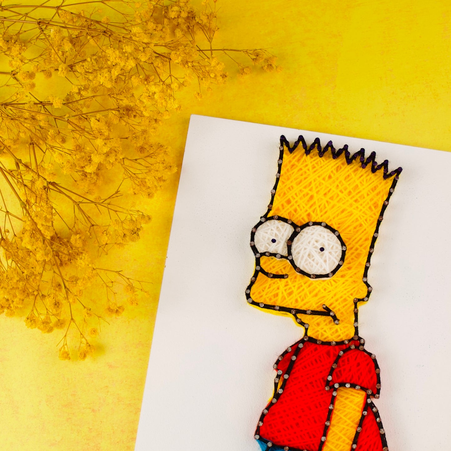 Creative yarn and nail art of Bart Simpson, perfect gift for fans of The Simpsons and handmade decor.