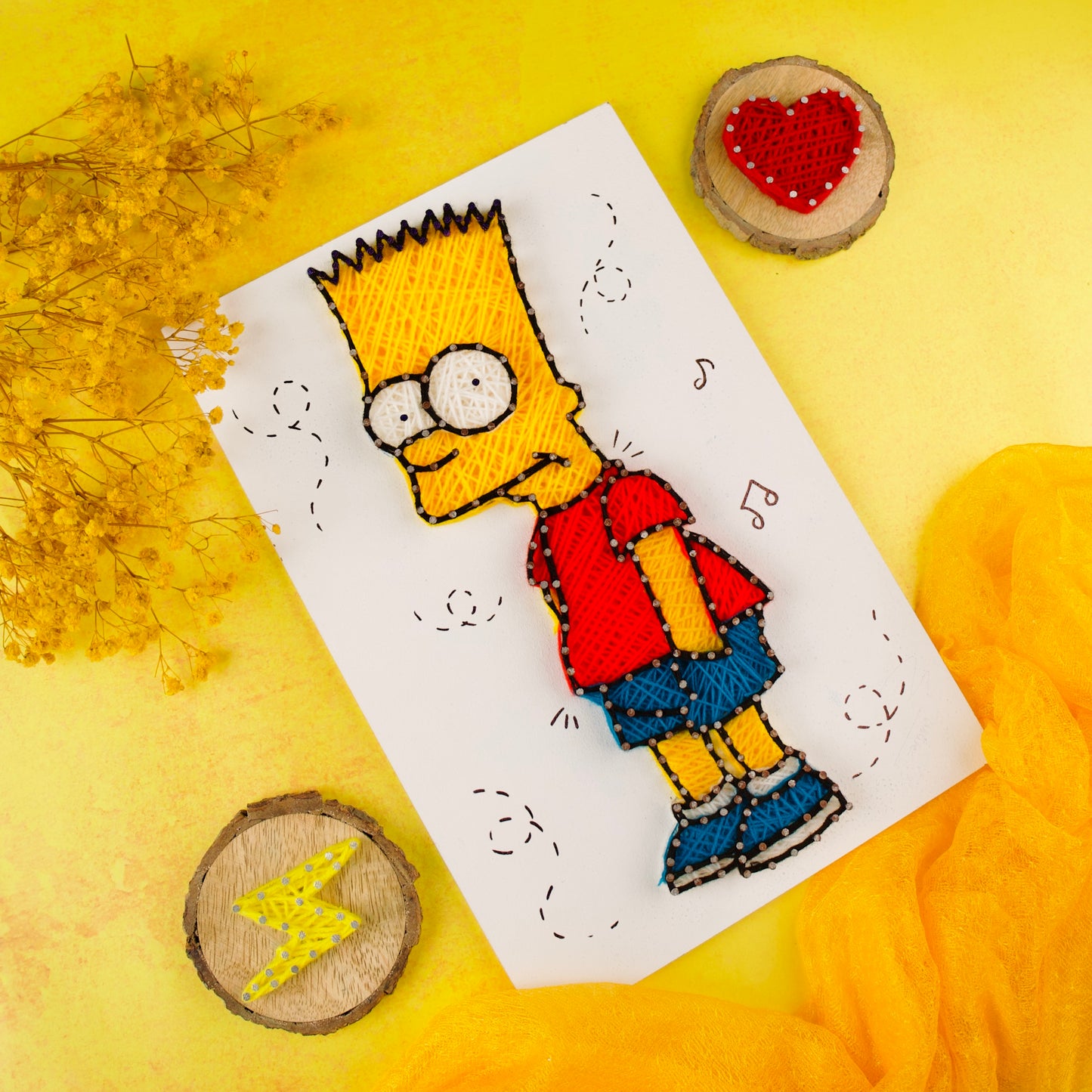 Colorful string art featuring Bart Simpson character, crafted on white board for playful home decor.