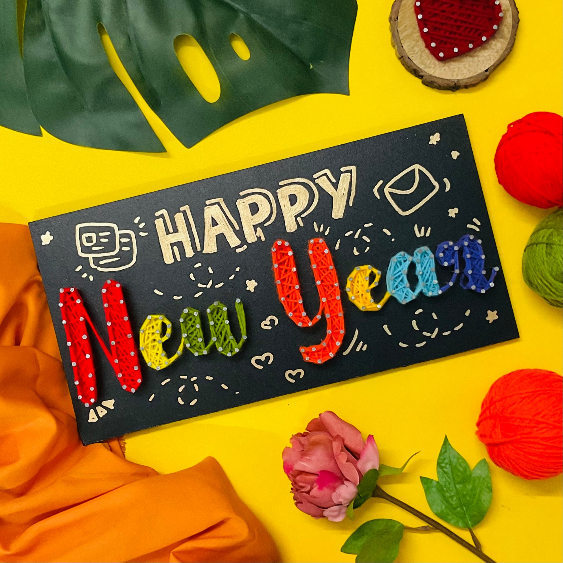 Vibrant “Happy New Year” handmade string art with rainbow-colored yarn – unique 2025 home or party decoration.