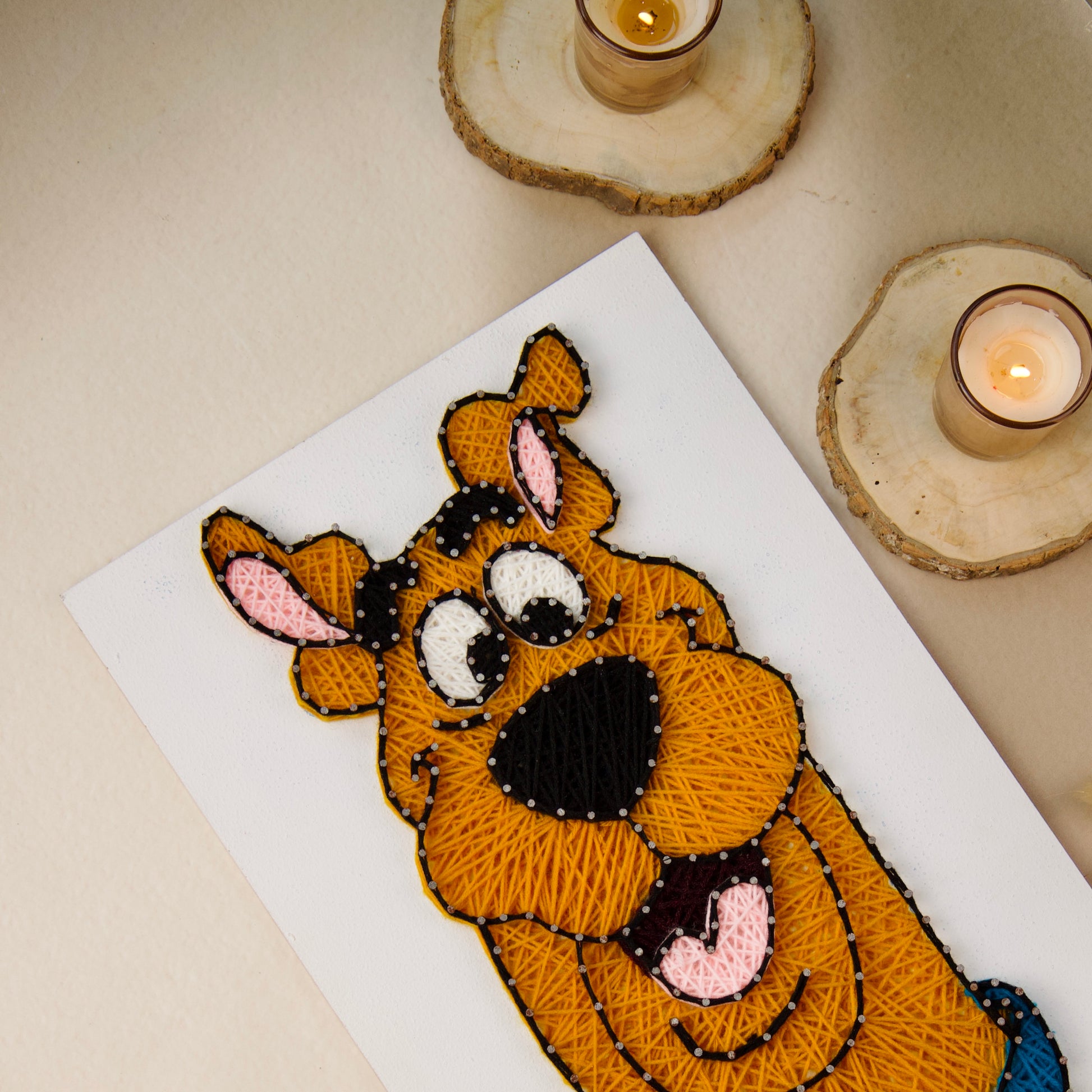 Handcrafted Scooby-Doo string art with vibrant threads, great gift for fans of classic cartoons.