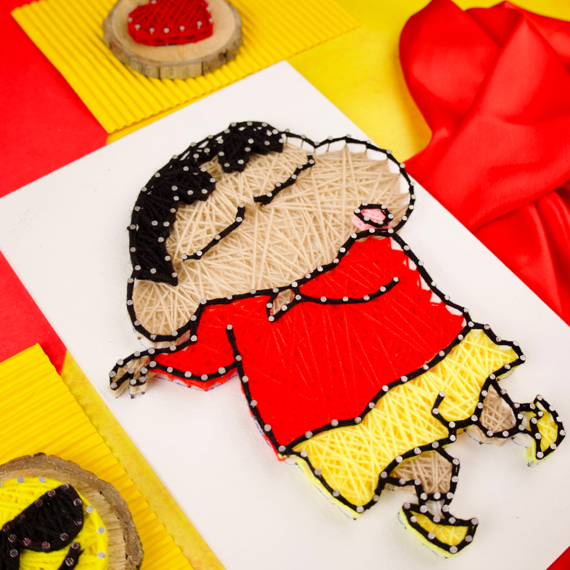 Shinchan string art in red and yellow threads, perfect handmade decor for cartoon lovers and kids.