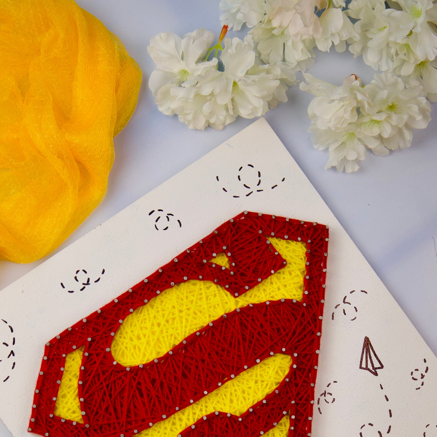 Custom string art featuring Superman emblem, ideal handmade room decor or geeky gift option.