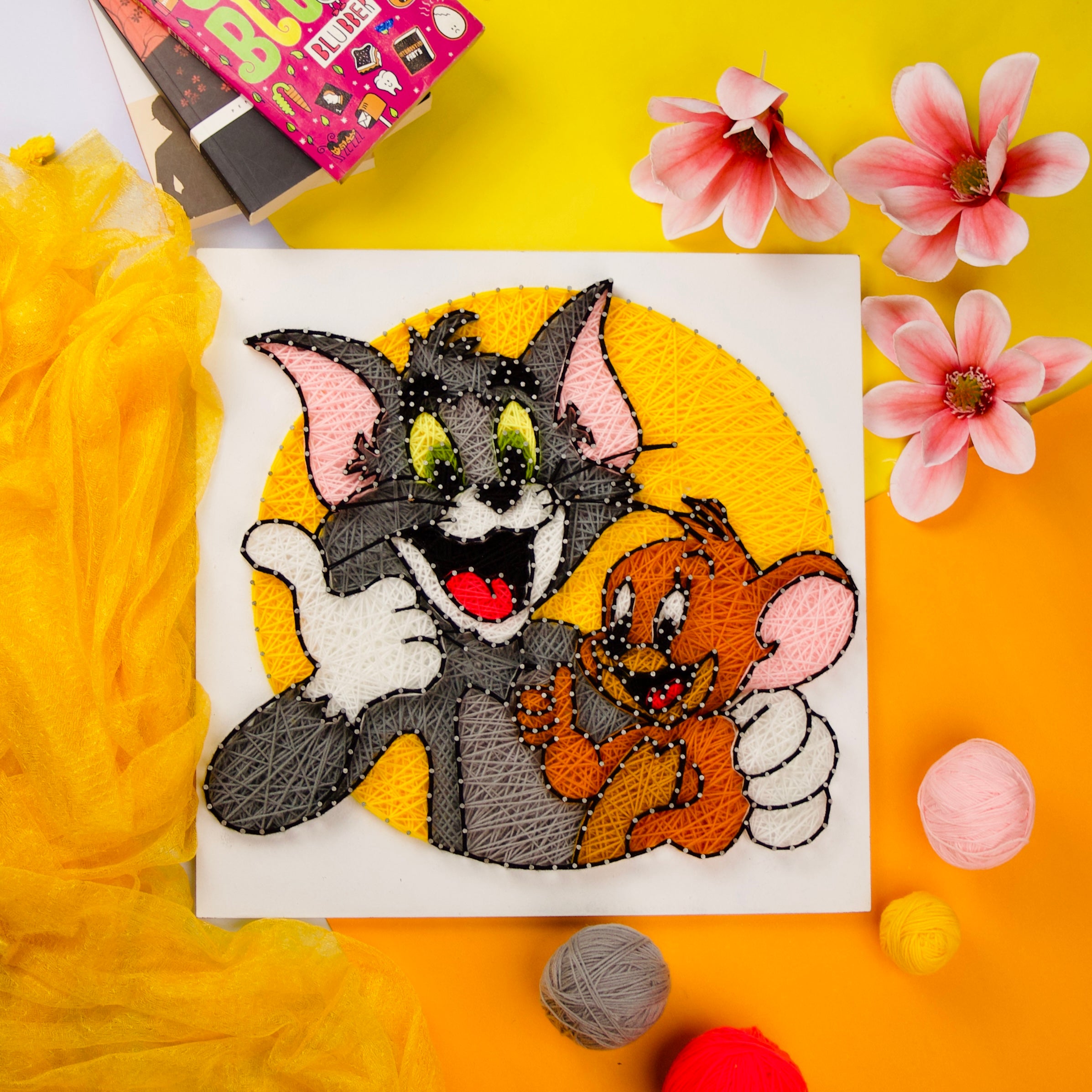 Tom and Jerry string art with vibrant colors, unique handmade decor piece for home or office.