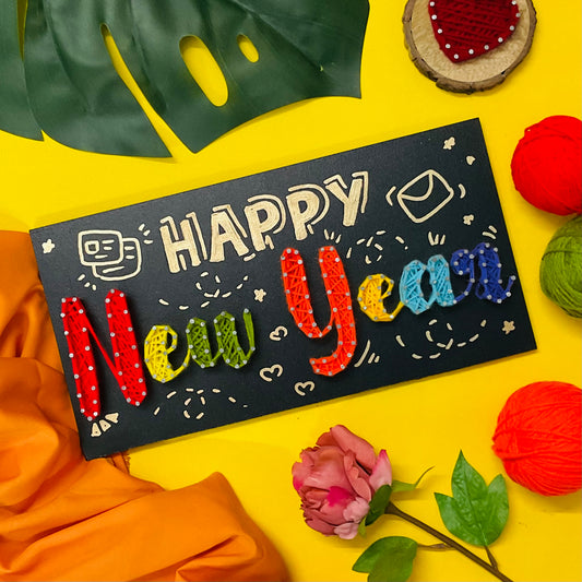 Vibrant “Happy New Year” handmade string art with rainbow-colored yarn – unique 2025 home or party decoration.